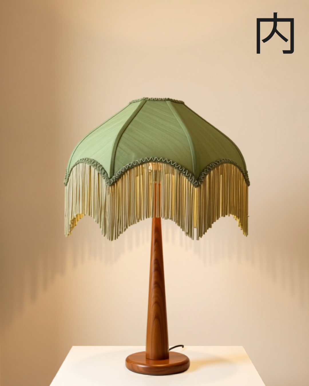Palm lampshade - scalloped sage-green lampshade with golden fringe that echoes swaying palm fronds